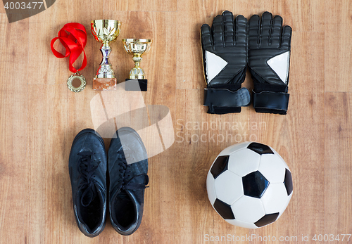 Image of ball, football boots, gloves, cups and medal