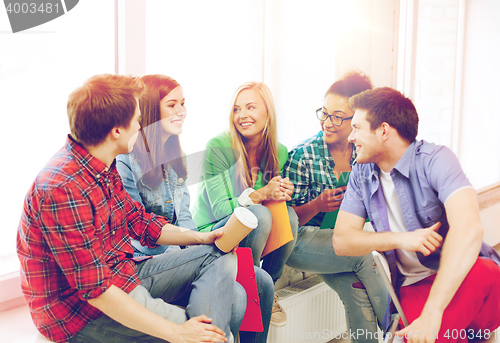 Image of students communicating and laughing at school