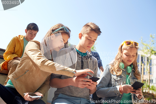 Image of teenage friends with smartphone and headphones