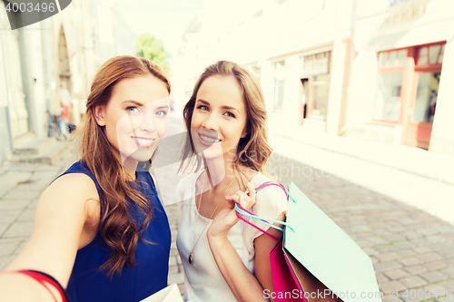 Image of women shopping and taking selfie by smartphone