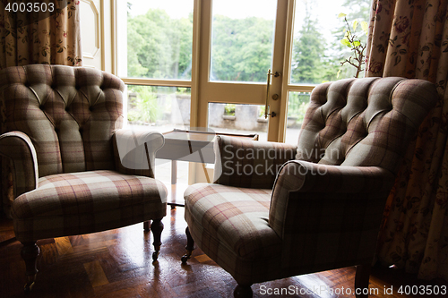 Image of close up of vintage armchairs and table in hotel