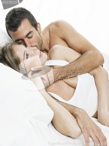 Image of romantic couple sleeping in a white bed