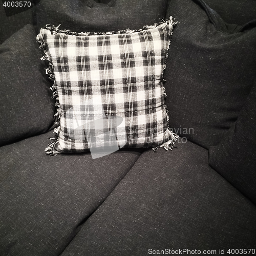 Image of Checked cushion on a dark gray sofa