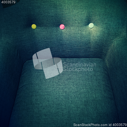 Image of Stylish armchair with colorful decorative buttons