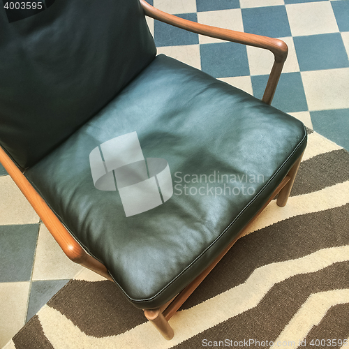 Image of Leather armchair in retro style interior
