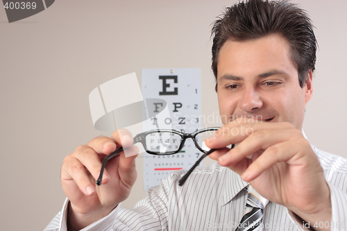 Image of Optometrist examining eye glasses