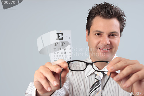 Image of Optometrist holding eye frames