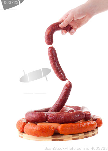 Image of hand holding sausages