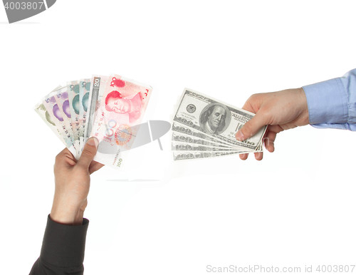 Image of Hands holding yuan and dollar bills