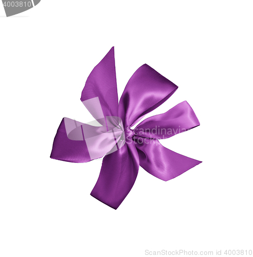 Image of purple gift ribbon with bow isolated on white background