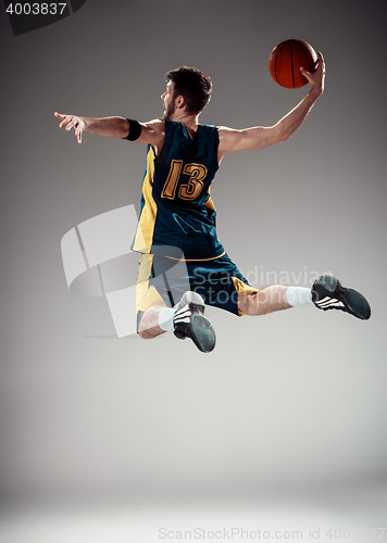 Image of Full length portrait of a basketball player with ball