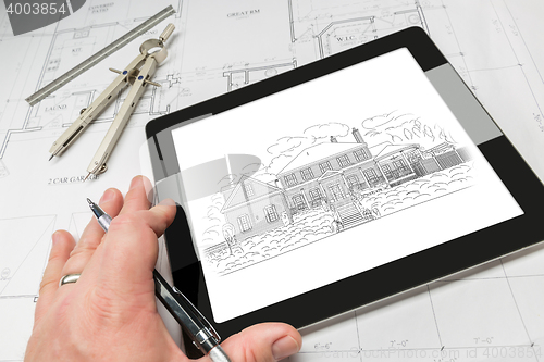 Image of Hand of Architect on Computer Tablet Showing Home Illustration O