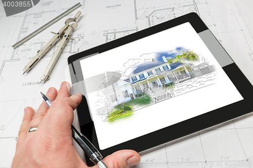 Image of Hand of Architect on Computer Tablet Showing Home Illustration O