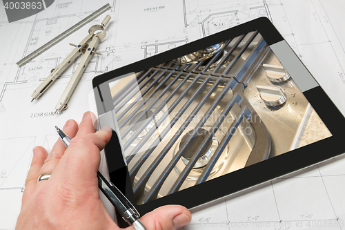 Image of Hand of Architect on Computer Tablet Showing Stove Details Over 