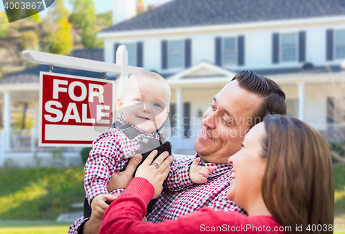 Image of Young Family In Front of For Sale Sign and House