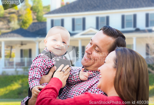 Image of Baby Having Fun With Mother and Father Out Front