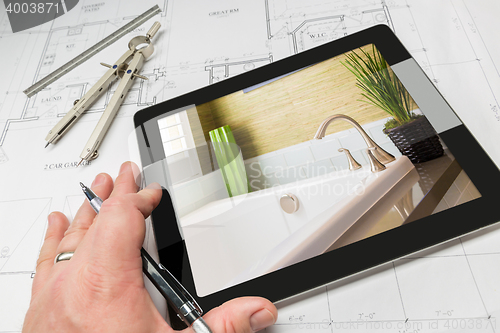 Image of Hand of Architect on Computer Tablet Showing Bathroom Details Ov