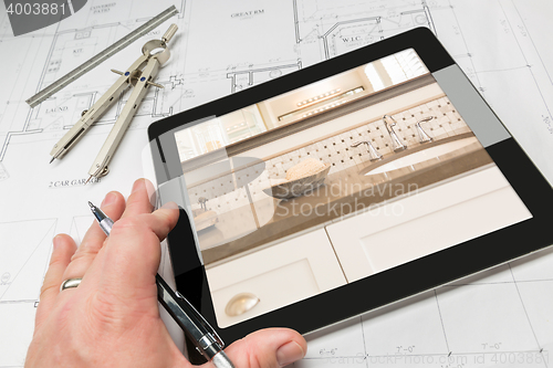 Image of Hand of Architect on Computer Tablet Showing Bathroom Details Ov