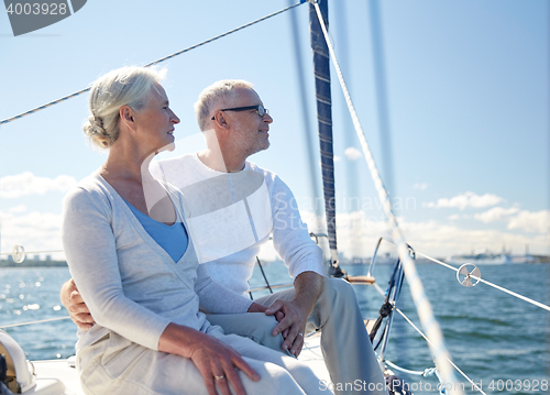 Image of senior couple hugging on sail boat or yacht in sea