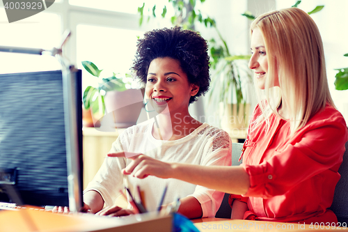 Image of happy women or students with computer in office