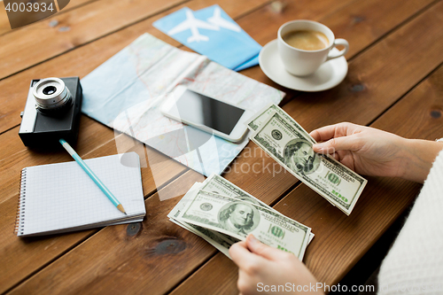 Image of close up of traveler hands counting dollar money