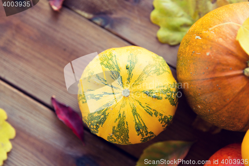 Image of close up of pumpkins on wooden table at home