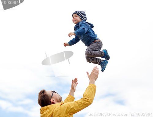 Image of father with son playing and having fun outdoors