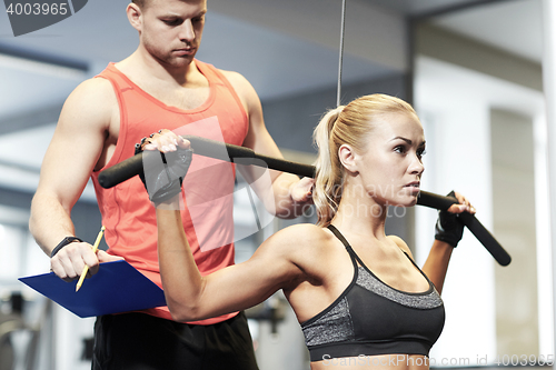 Image of man and woman flexing muscles on gym machine