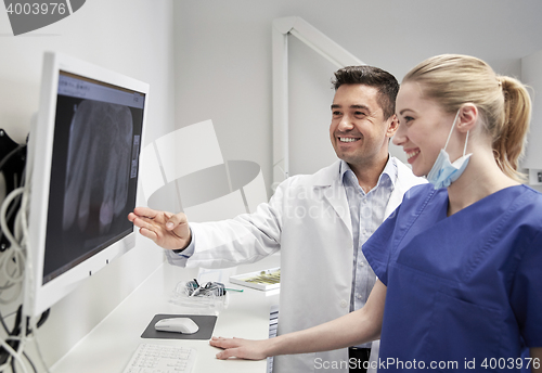 Image of dentists with x-ray on monitor at dental clinic