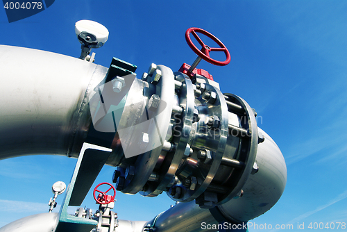 Image of Industrial zone, Steel pipelines and valves against blue sky