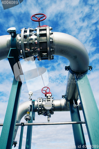 Image of Industrial zone, Steel pipelines and valves against blue sky