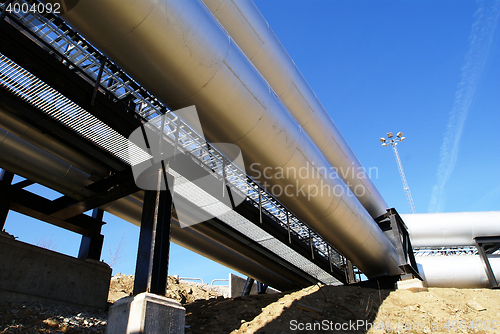 Image of Industrial zone, Steel pipelines and valves against blue sky