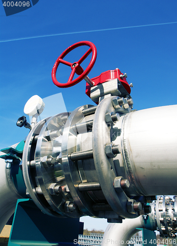 Image of Industrial zone, Steel pipelines and valves against blue sky