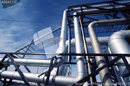 Image of Industrial zone, Steel pipelines and valves against blue sky