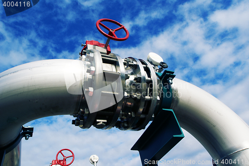 Image of Industrial zone, Steel pipelines and valves against blue sky