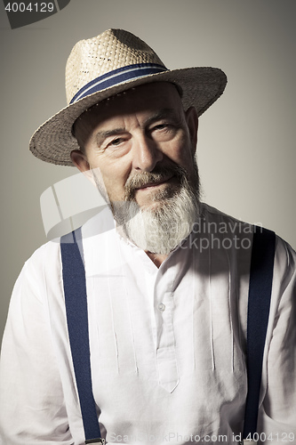 Image of senior male portrait with a hat