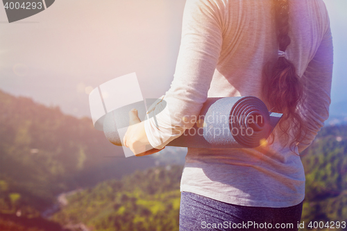 Image of Woman standing with yoga 