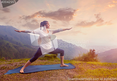 Image of Woman doing Ashtanga Vinyasa Yoga asana Virabhadrasana 2 Warrior