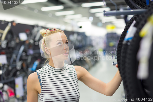 Image of Woman shopping sports equipment in sportswear store.