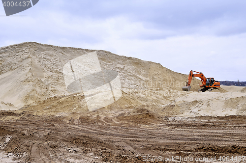 Image of Working digger in a quarry produces sand
