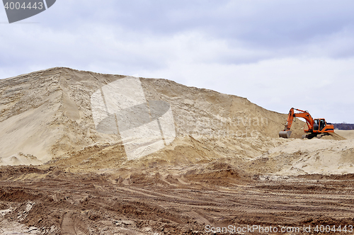 Image of Working digger in a quarry produces sand