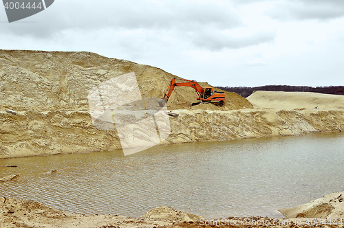 Image of Working digger in a quarry produces sand