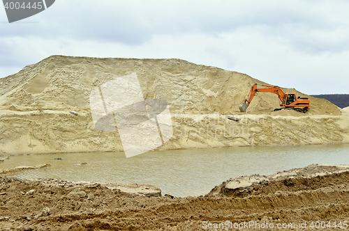 Image of Working digger in a quarry produces sand