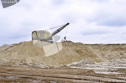 Image of Working digger in a quarry produces sand Working digger in a quarry produces sand