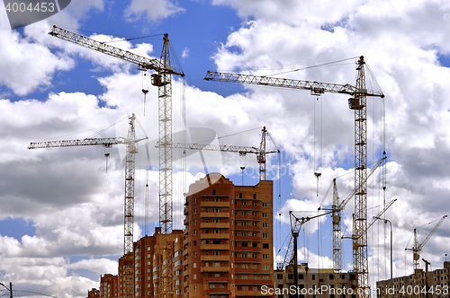 Image of  Construction site with cranes on sky background
