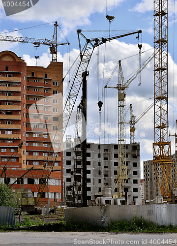 Image of  Construction site with cranes on sky background