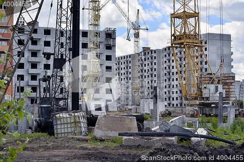 Image of  Construction site with cranes on sky background