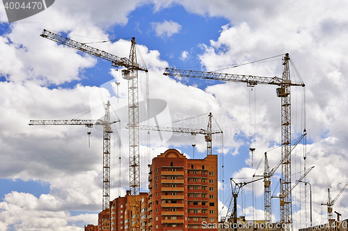 Image of  Construction site with cranes on sky background