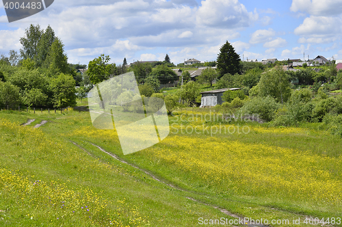 Image of Rural landscape with road and houses flowering meadow