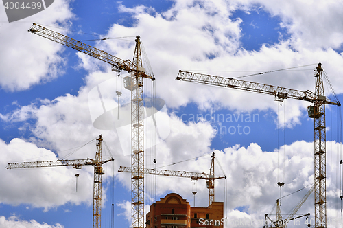 Image of  Construction site with cranes on sky background